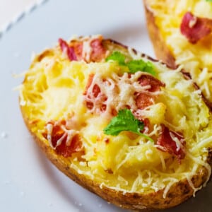 Twice baked potatoes on a white plate.