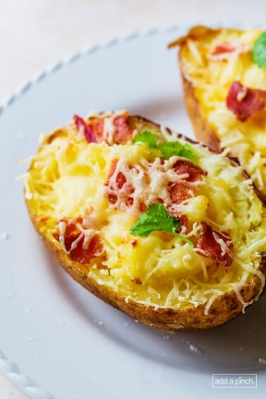 Twice baked potatoes on a white plate.