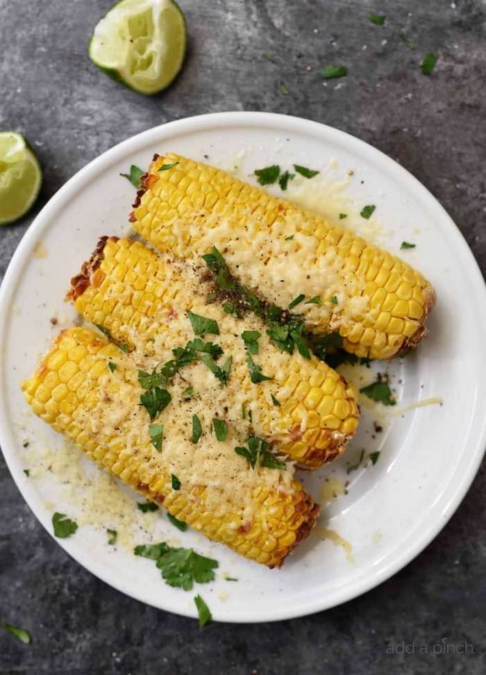 Air Fryer Mexican Street Corn Recipe - This flavorful, super easy Mexican Street Corn recipe is ready in 15 minutes in the air fryer and always a favorite! // addapinch.com