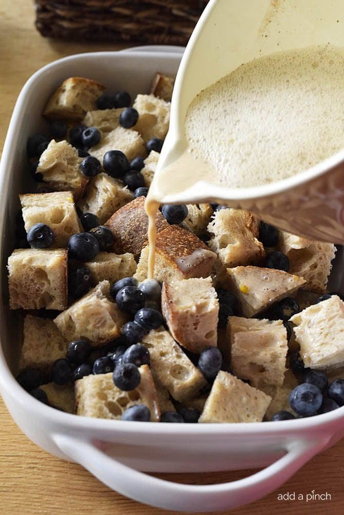 Baking dish A holds layers of cubed bread, fresh blueberries