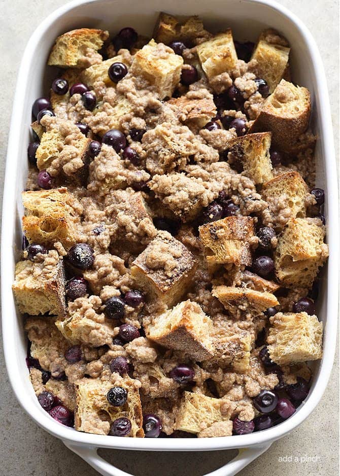 Blueberry French Toast ingredients in a white baking dish are ready to place in the oven to bake. 
