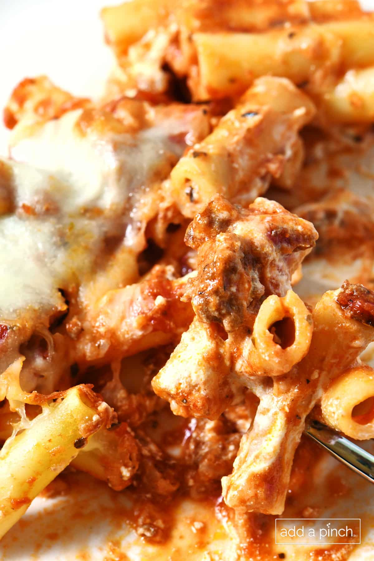 White plate filled with baked ziti.
