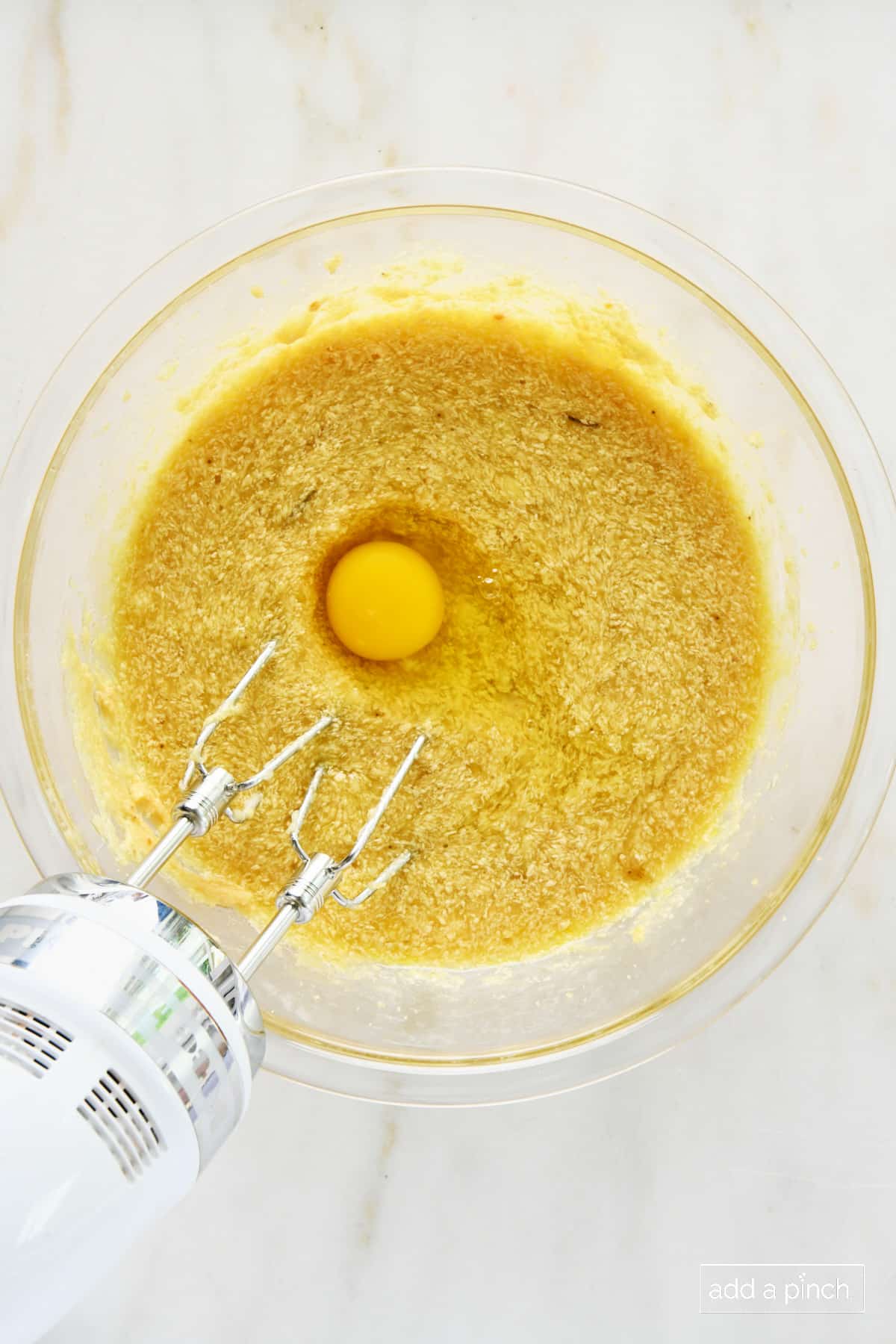 Egg added to banana muffin batter.