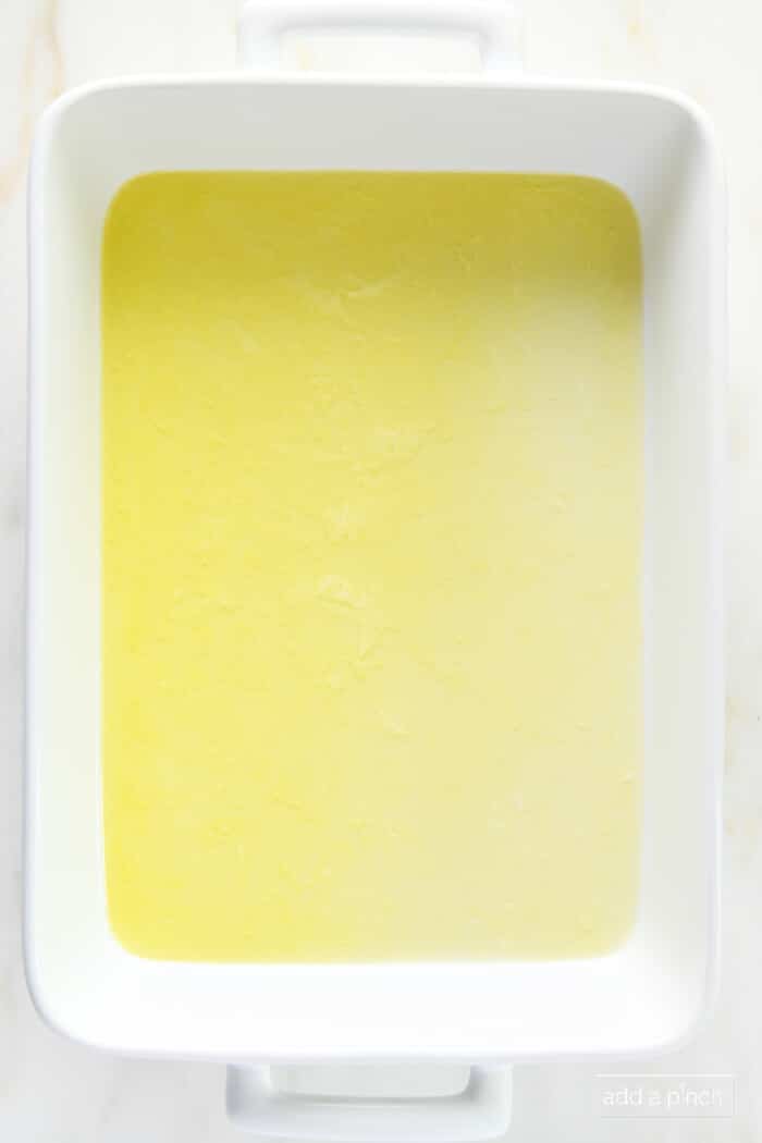 Melted butter in a white baking dish.
