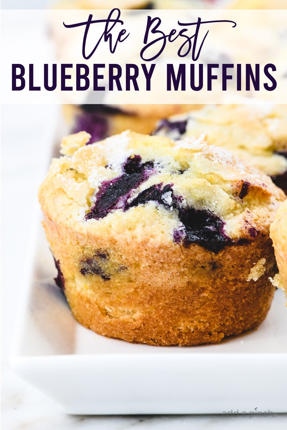 Blueberry muffins on white serving platter - with text - addapinch.com