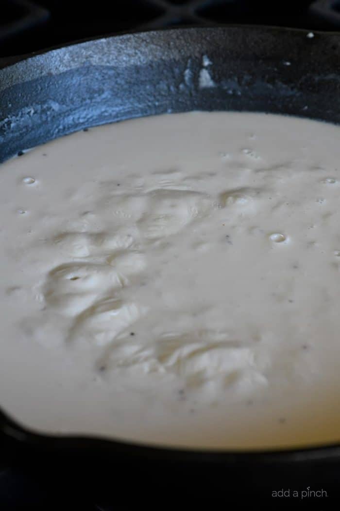 Cheese sauce bubbling in skillet.