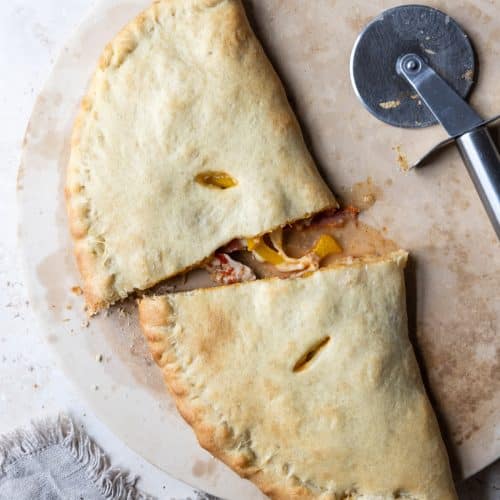 Homemade calzone on a pizza stone.