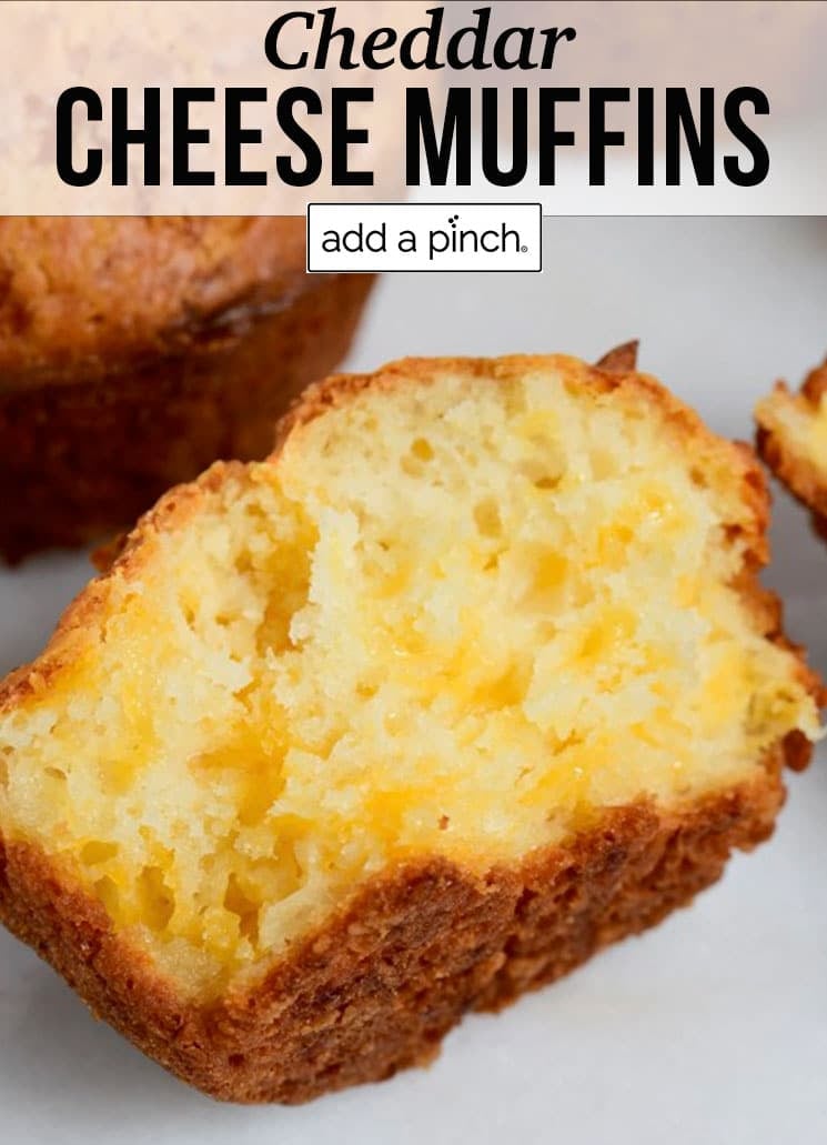 Melted cheese shows in split cheddar cheese muffins - with text - addapinch.com