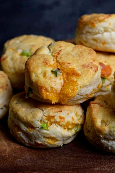 Cheddar Scallion Biscuits Recipe - Tender and delicious, these fluffy, cheesy cheddar scallion biscuits make the perfect addition to any meal and couldn't be easier! // addapinch.com