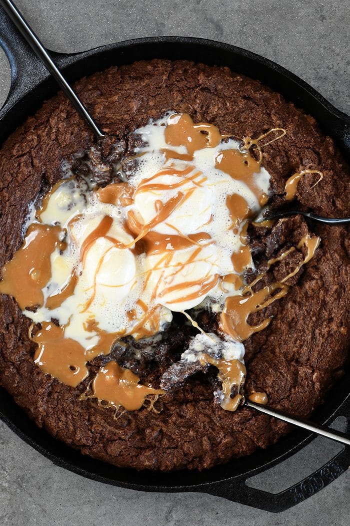 Double Chocolate Caramel Skillet Cookie Recipe - This scrumptious chocolate cookie recipe brings together the richness of chocolate and creamy caramel all in one delicious skillet recipe! // addapinch.com