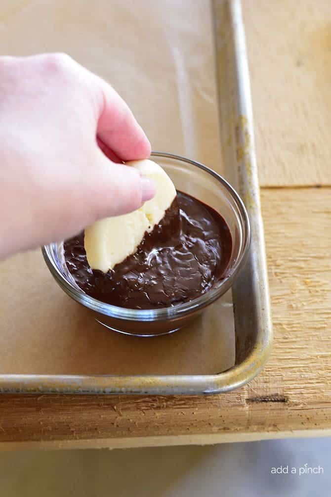 Chocolate Dipped Shortbread Cookies Recipe make a festive and delicious cookie recipe that chocolate lovers adore! Perfect for a make ahead cookie recipe! // addapinch.com