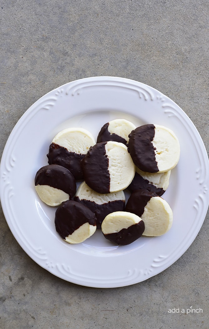 Chocolate Dipped Shortbread Cookies Recipe make a festive and delicious cookie recipe that chocolate lovers adore! Perfect for a make ahead cookie recipe! // addapinch.com