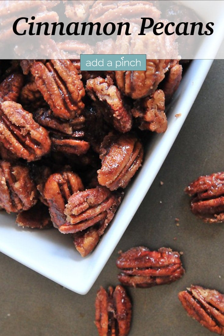 Cinnamon Pecans in white serving dish - with text - addapinch.com