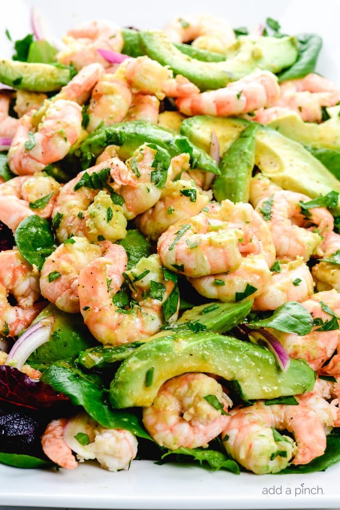 Citrus Shrimp Avocado Salad on a white platter on white marble. 