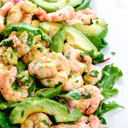 Photograph of Citrus Shrimp Avocado Salad on a white platter on white marble. // addapinch.com