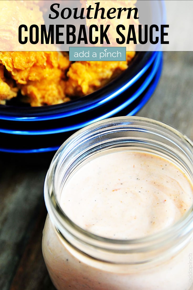Comeback Sauce in jar with fried chicken fingers on blue plate in background - with text - addapinch.com