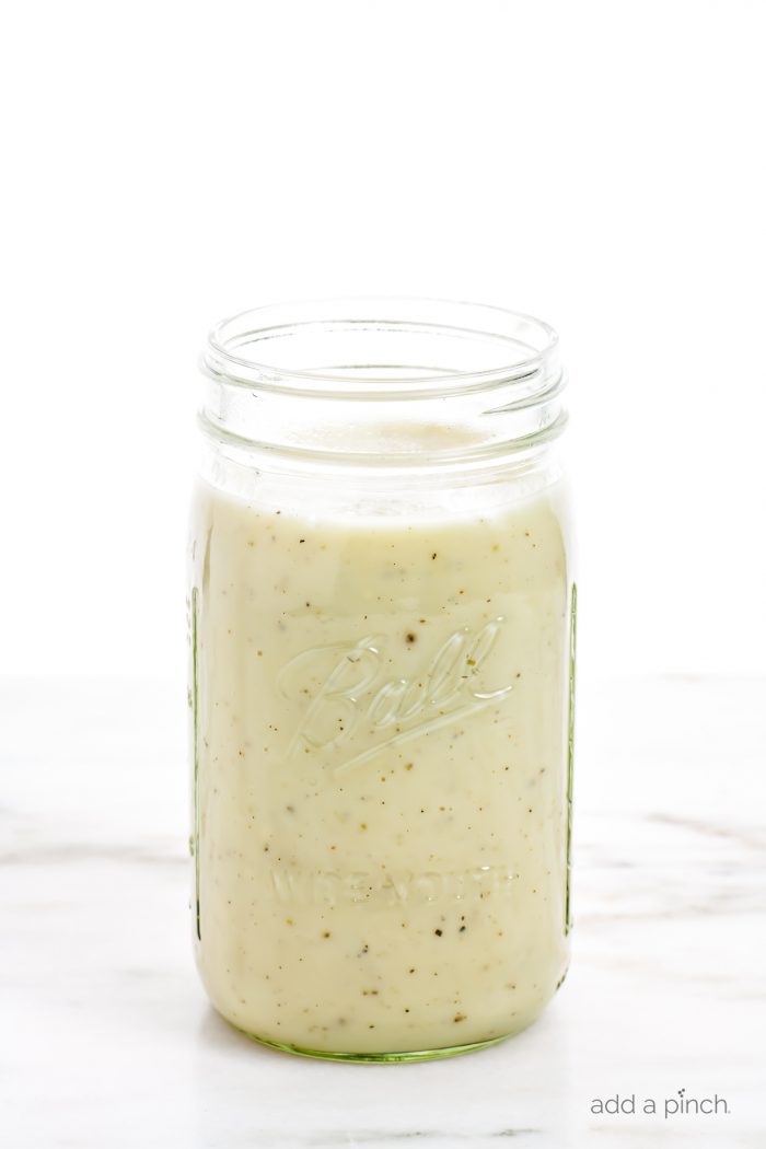 Condensed Cream of Chicken Soup - image of clear glass jar filled with homemade condensed cream of chicken soup on a marble countertop.