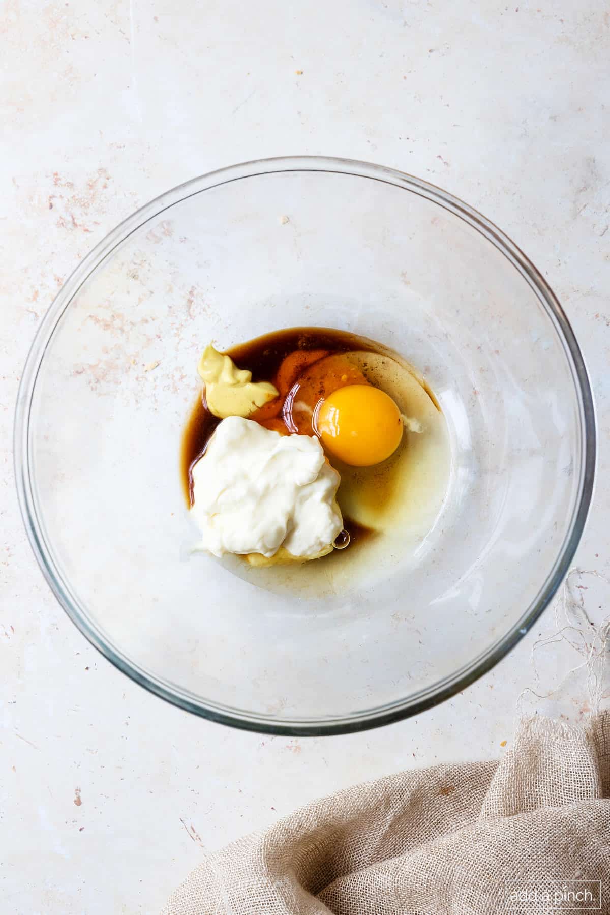 Ingredients for crab cakes in a glass bowl.