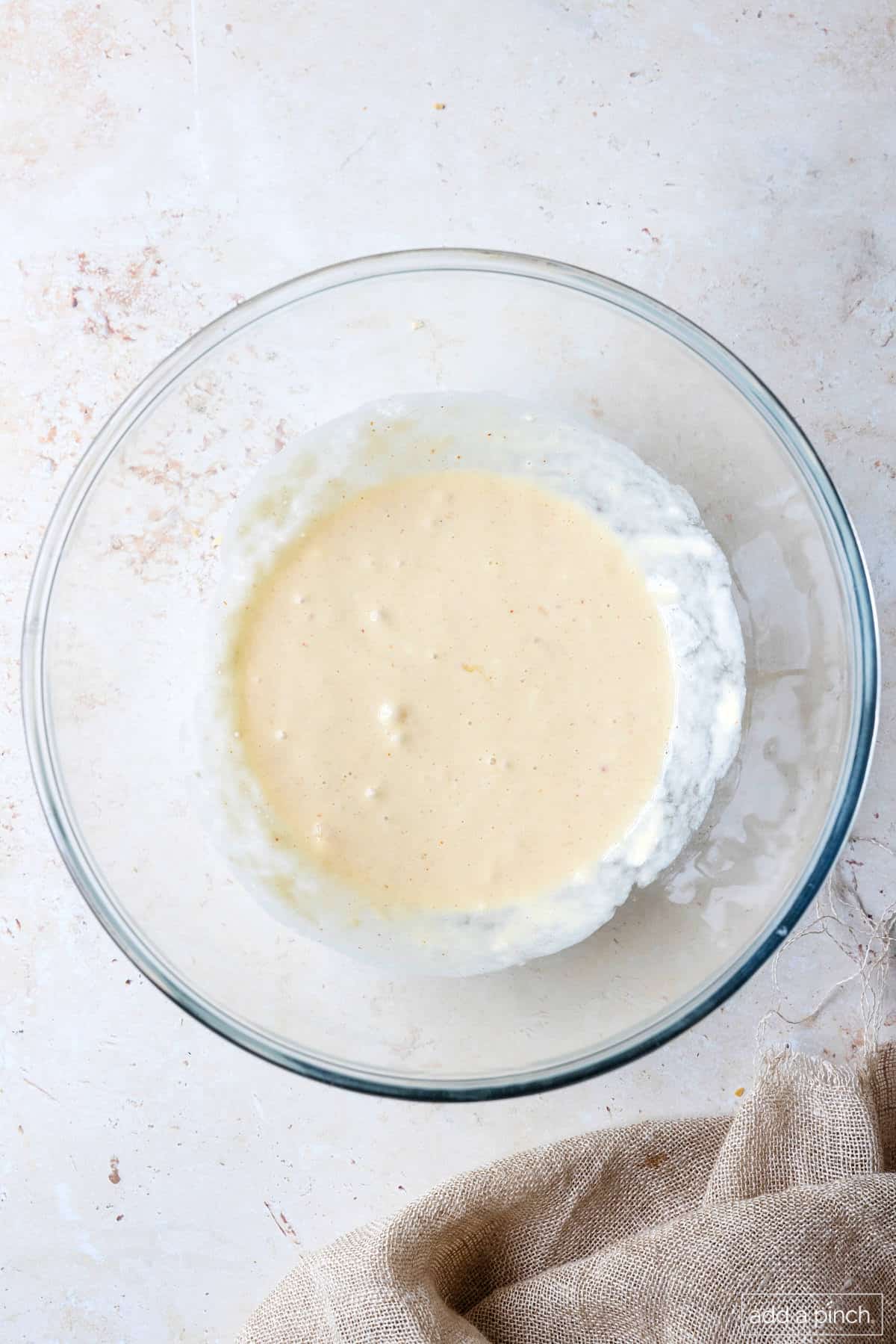 Whisked together wet ingredients in a glass mixing bowl.