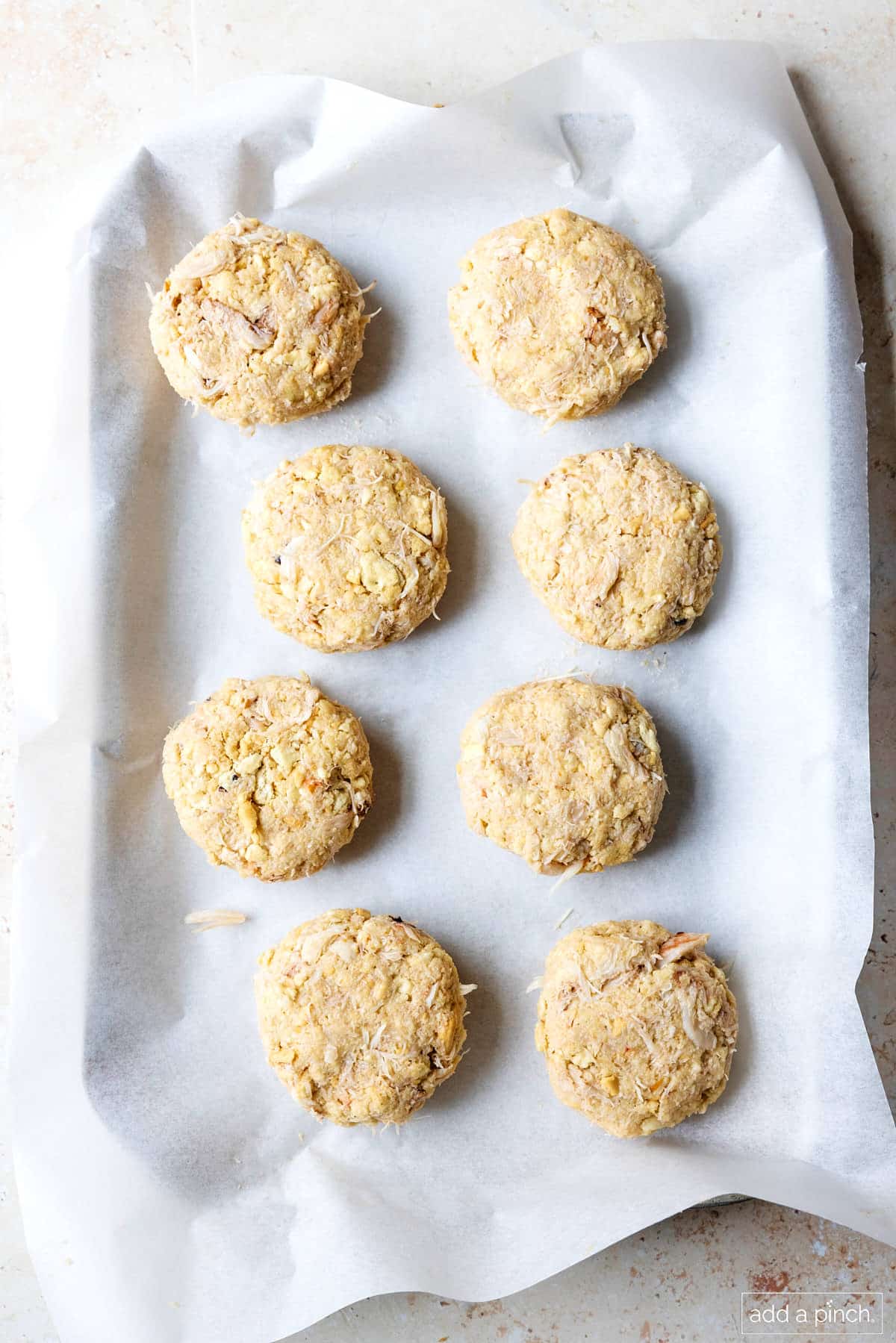Baking sheet with wax paper holds 8 formed crab cake patties.
