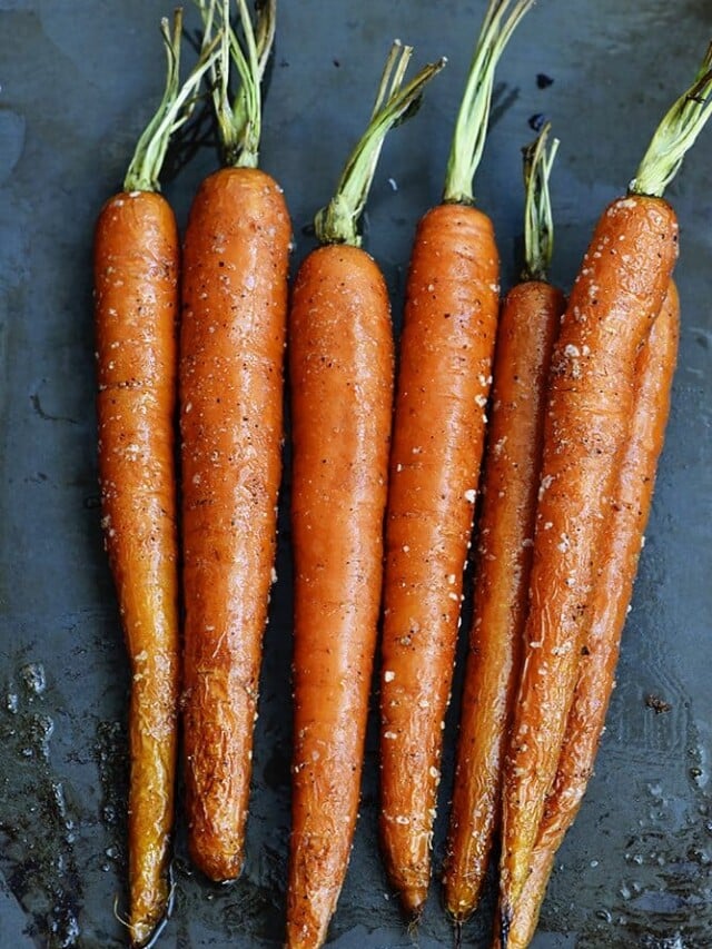 Photo of Garlic Roasted Carrots on gray background.