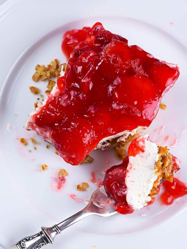 Strawberry Pretzel Salad on plate with fork - addapinch.com