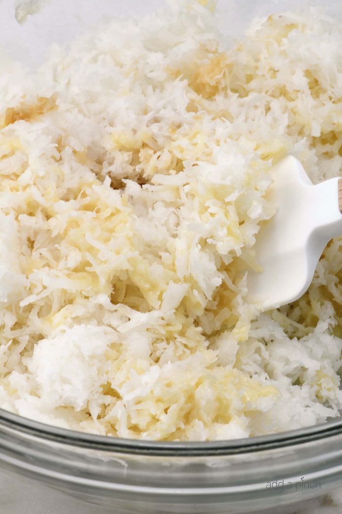 Coconut Macaroon mixture in glass bowl, marble counter.