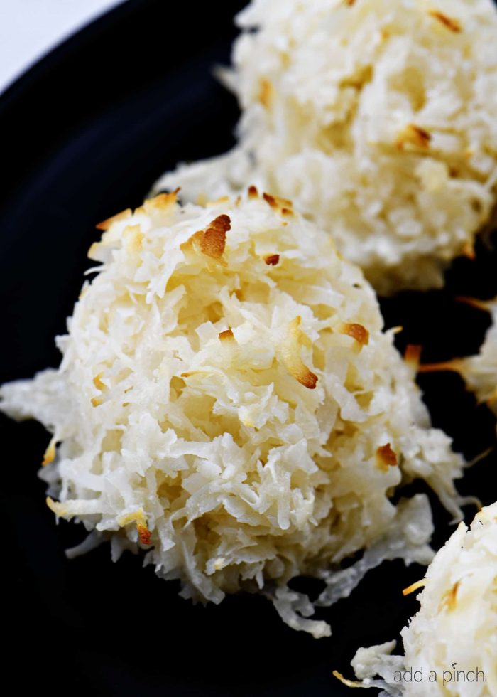 Coconut macaroons with golden brown flakes from baking, on a dish.