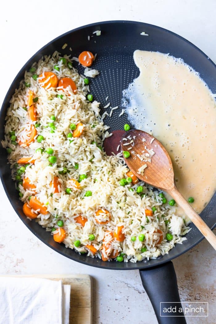 Photo of egg added to fried rice.