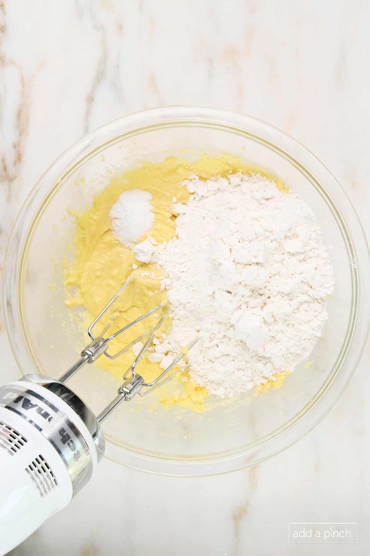 Added dry ingredients to cookie dough mixture in glass mixing bowl