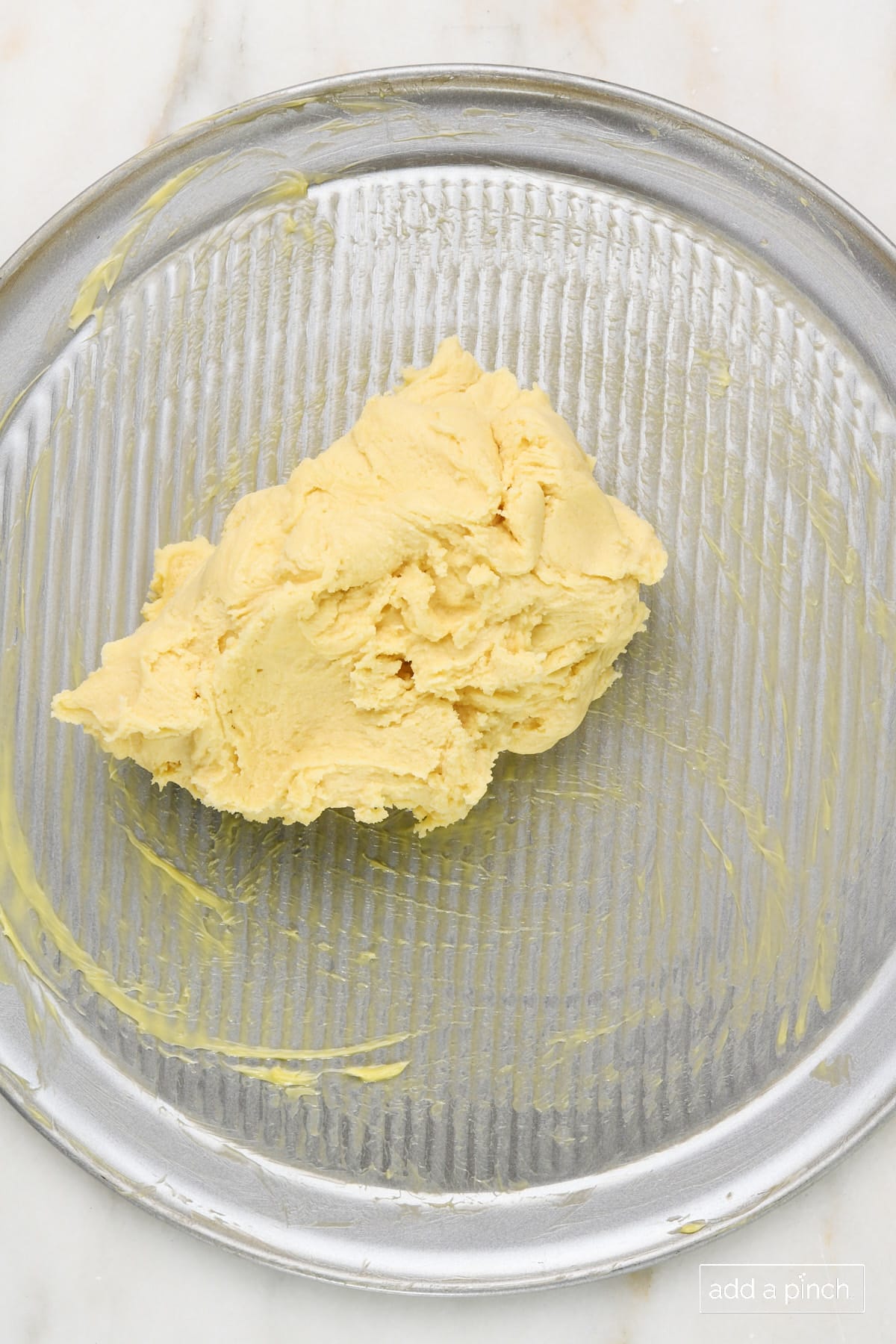 Add chilled dough to pizza dough pan