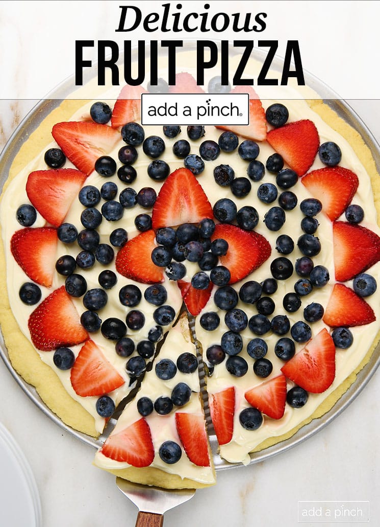 Berry and cream cheese frosting top a cookie pizza - with text - addapinch.com