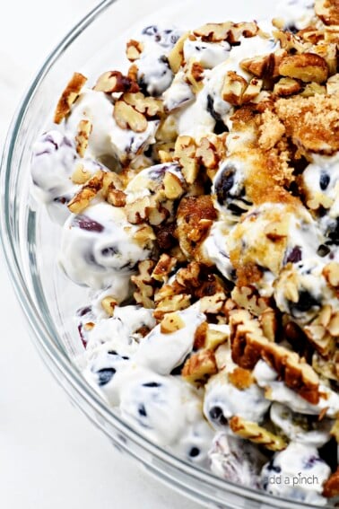 Grape Salad Recipe - Grape salad makes an easy and delicious side dish or dessert! Creamy, crunchy and absolutely out of this world, it makes a family favorite recipe! // addapinch.com