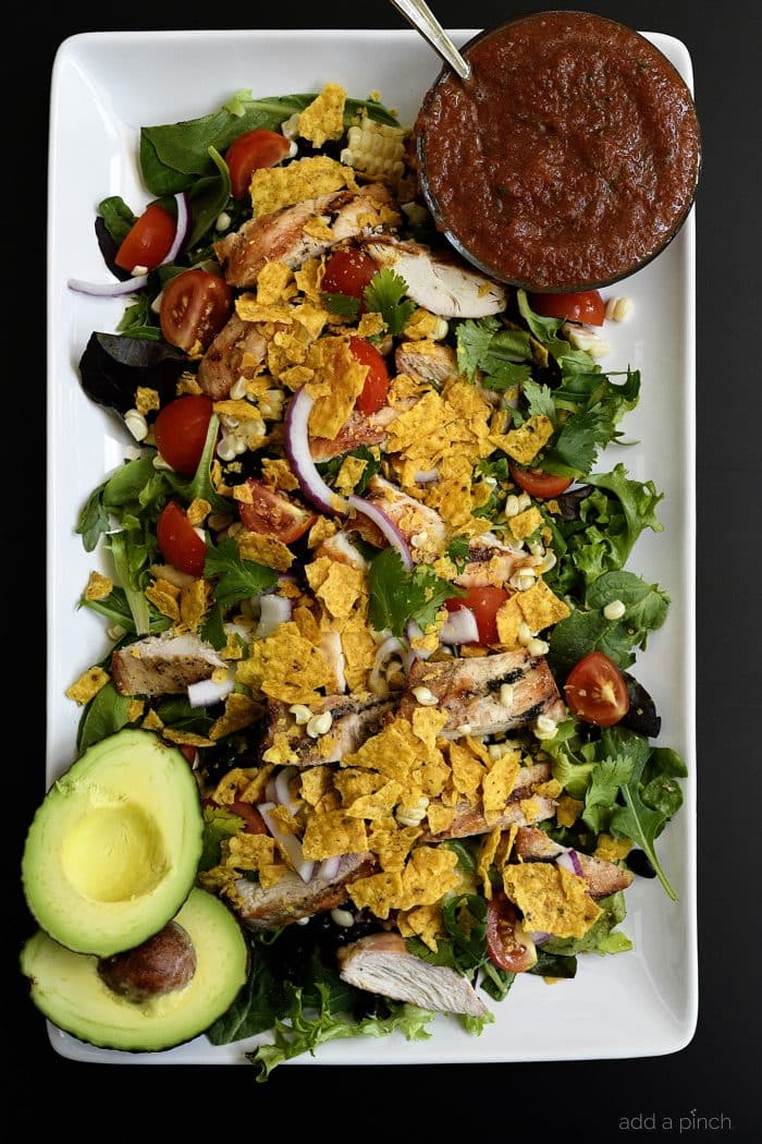 Grilled Chicken Fiesta Salad Recipe - This simple grilled chicken salad recipe is kicked up a notch for a spicy Tex-Mex favorite! // addapinch.com