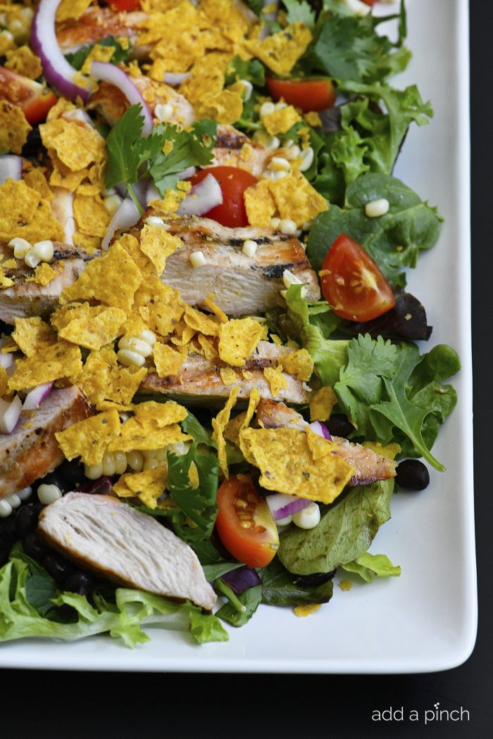 Grilled Chicken Fiesta Salad Recipe - This simple grilled chicken salad recipe is kicked up a notch for a spicy Tex-Mex favorite! // addapinch.com