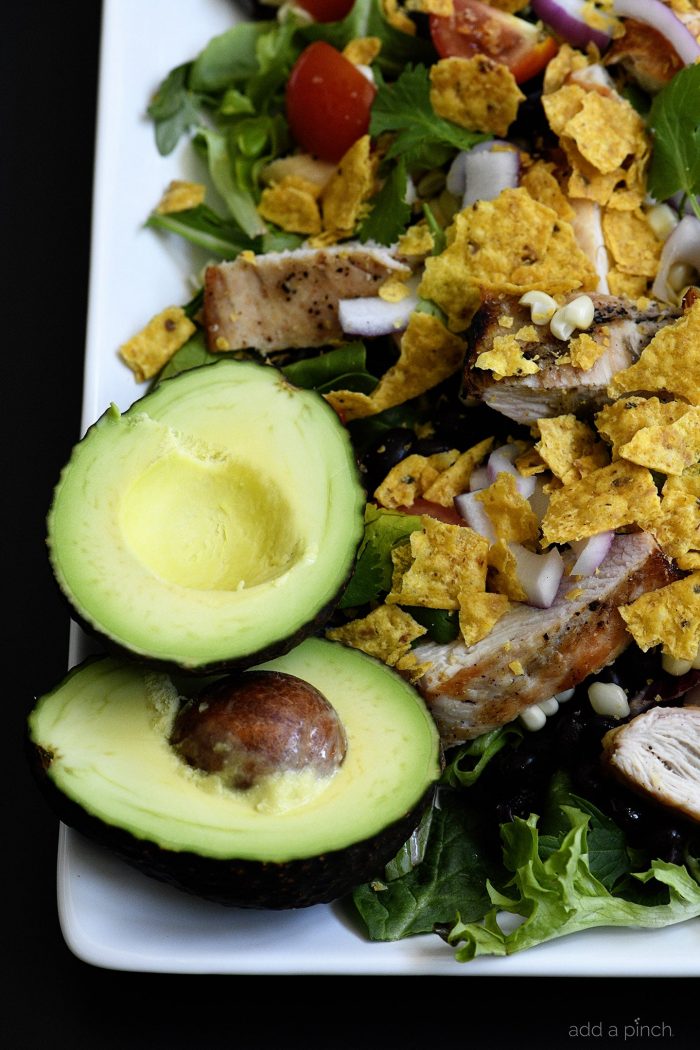 Grilled Chicken Fiesta Salad Recipe - This simple grilled chicken salad recipe is kicked up a notch for a spicy Tex-Mex favorite! // addapinch.com