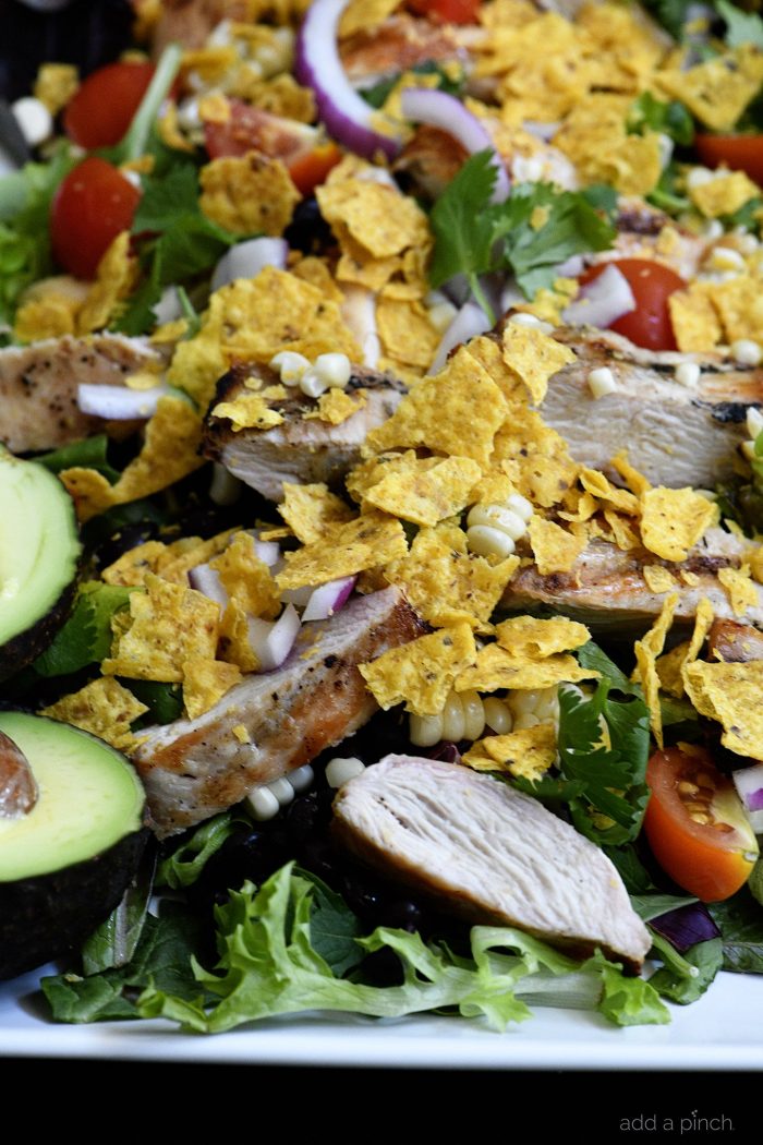 Grilled Chicken Fiesta Salad Recipe - This simple grilled chicken salad recipe is kicked up a notch for a spicy Tex-Mex favorite! // addapinch.com