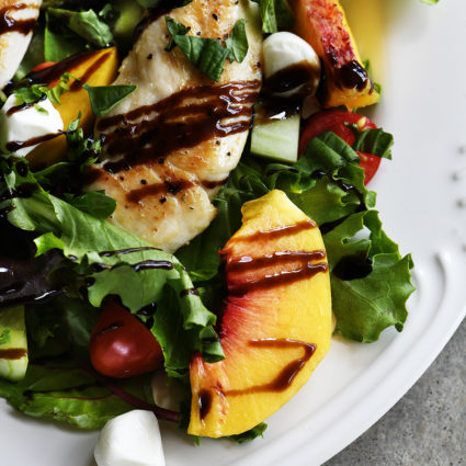 Grilled Chicken and Peach Salad Recipe - A light and delicious dish  that is perfect for lunch or dinner. Made with grilled chicken, fresh juicy peaches, and topped with tangy balsamic. // addapinch.com