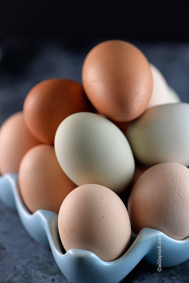 Blue ceramic egg dish with various shades of eggs from beige to brown -addapinch.com