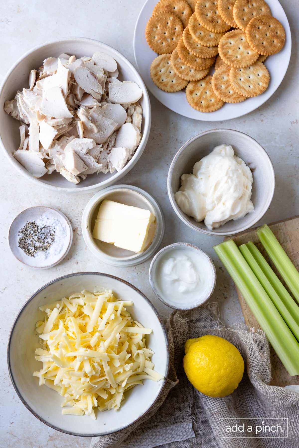 Ingredients to make hot chicken salad recipe on a white surface.