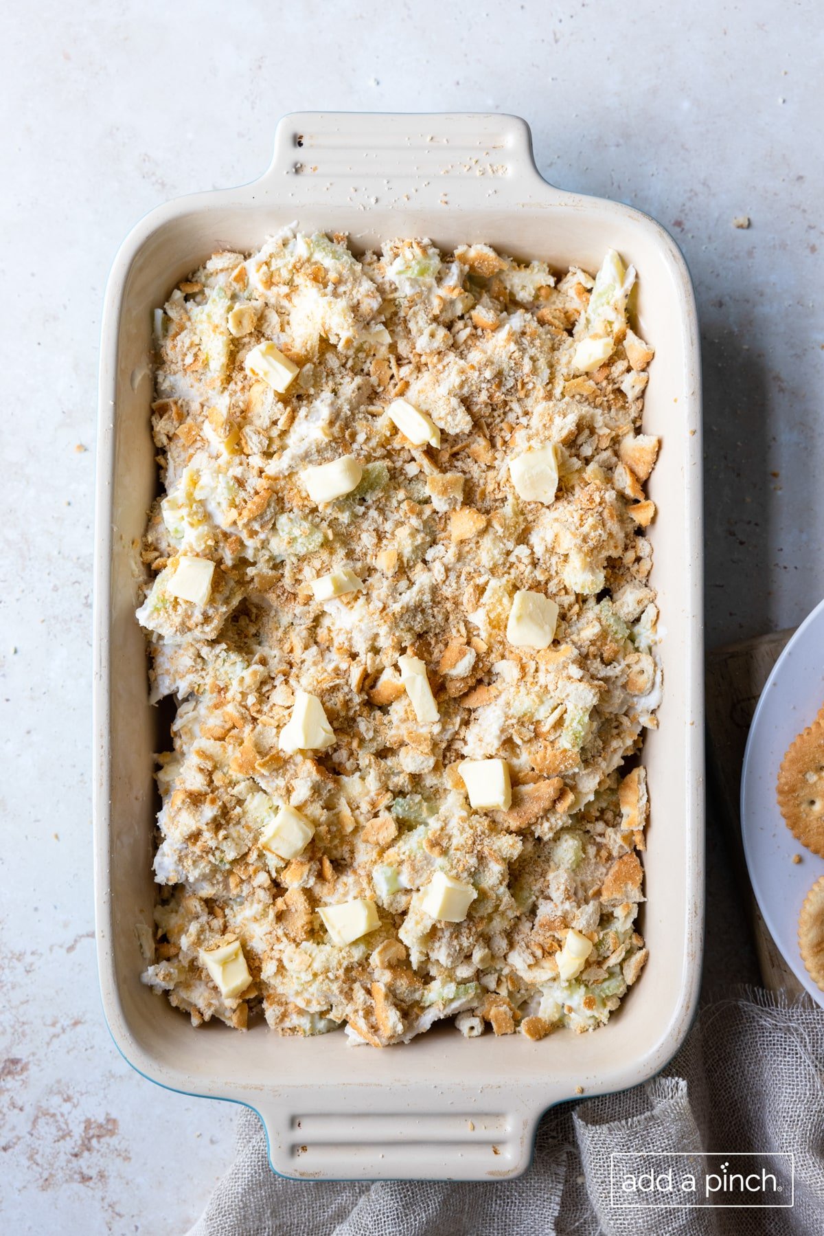 Salad mixture in baking dish with cracker and butter topping added.