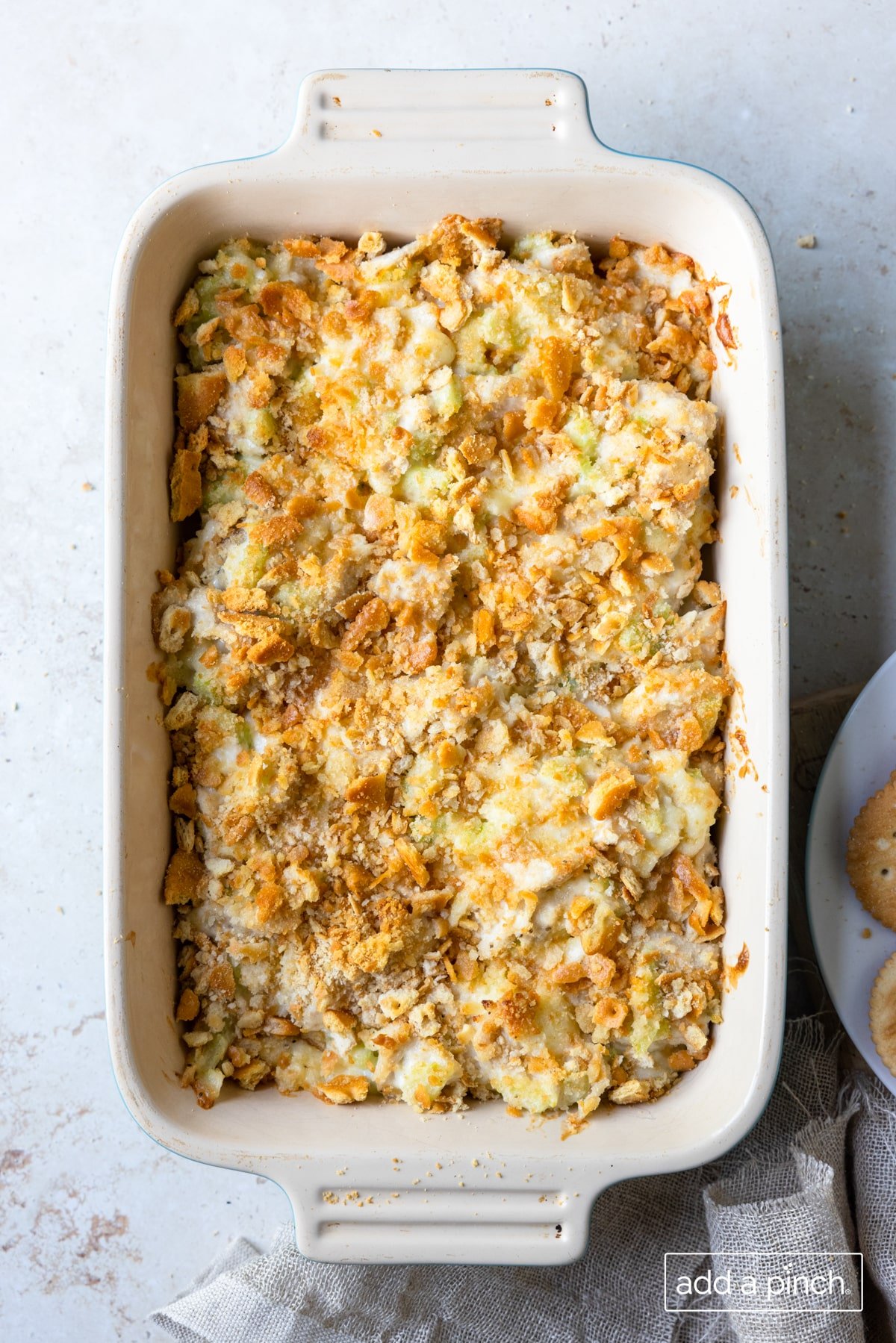 Baked salad in a baking dish on a white surface.