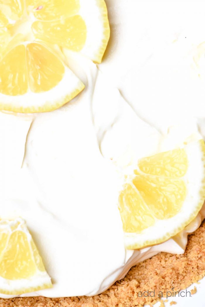 This no bake lemon cream pie is a quick and easy twist on the classic. Made with cream cheese, cream, and lots of lemon with a buttery graham cracker crust. // addapinch.com