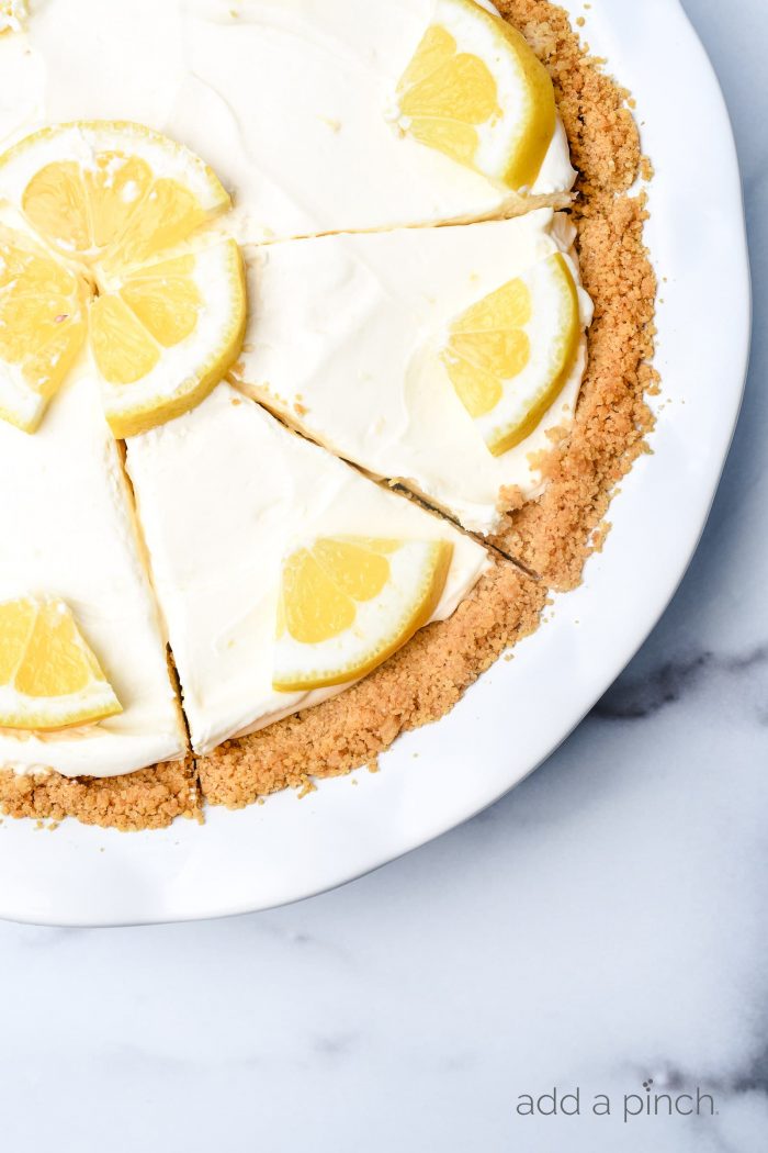 This no bake lemon cream pie is a quick and easy twist on the classic. Made with cream cheese, cream, and lots of lemon with a buttery graham cracker crust. // addapinch.com