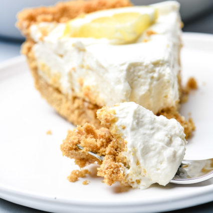 This no bake lemon cream pie is a quick and easy twist on the classic. Made with cream cheese, cream, and lots of lemon with a buttery graham cracker crust. // addapinch.com