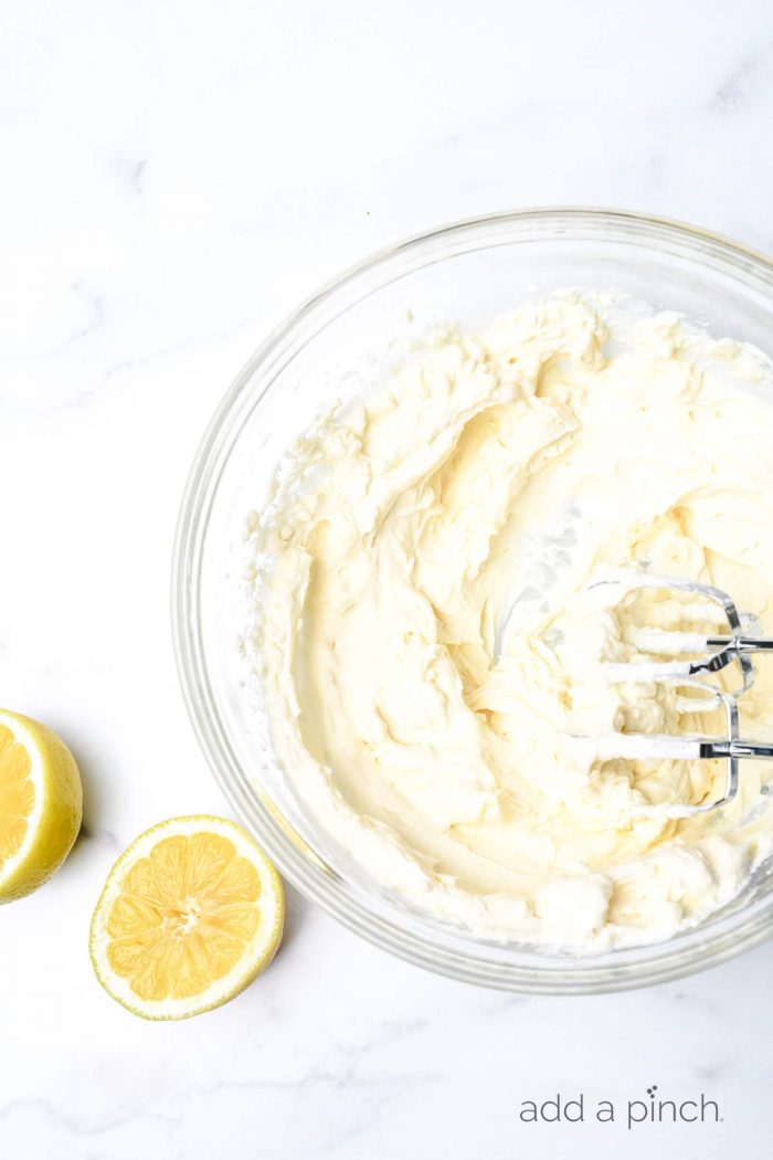 This no bake lemon cream pie is a quick and easy twist on the classic. Made with cream cheese, cream, and lots of lemon with a buttery graham cracker crust. // addapinch.com