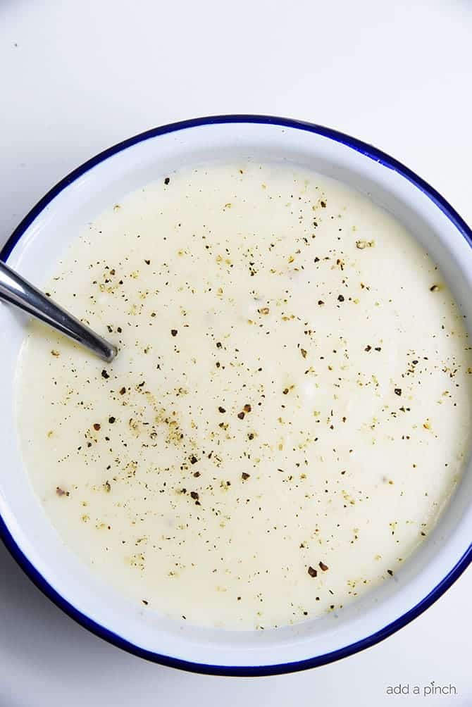 Loaded Baked Potato Soup Recipe - Loaded baked potato soup makes a warm, comforting potato soup recipe. Made with baked potatoes blended into a creamy soup and topped with your potato bar favorites! // addapinch.com