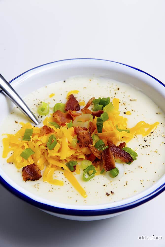 Loaded Baked Potato Soup Recipe - Loaded baked potato soup makes a warm, comforting potato soup recipe. Made with baked potatoes blended into a creamy soup and topped with your potato bar favorites! // addapinch.com