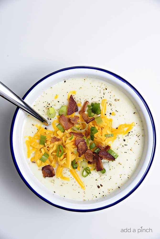 Loaded Baked Potato Soup Recipe - Loaded baked potato soup makes a warm, comforting potato soup recipe. Made with baked potatoes blended into a creamy soup and topped with your potato bar favorites! // addapinch.com
