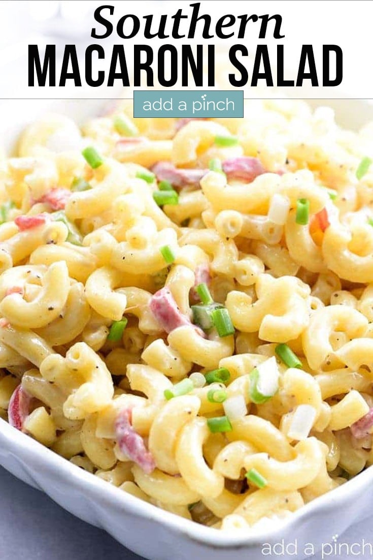 White serving bowl filled with macaroni salad - with text - addapinch.com